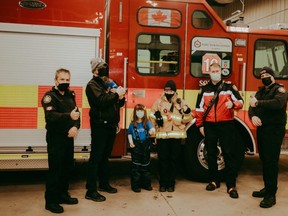 Cecily Kalyn poses with the Fort Saskatchewan Fire Department team. Photo courtesy A. Keen Photography