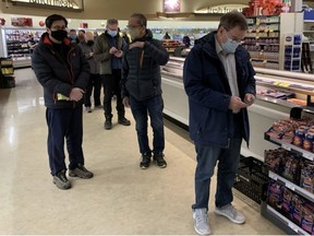 People line up to get a free box of five COVID-19 Antigen rapid tests at a Capilano pharmacy on Friday, Dec. 17. GREG SOUTHAM/Postmedia