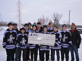 The Leduc U15 2 Roughnecks presented the Stollery Children’s Hospital with a cheque for $538.53, funds raised from a botttle drive, on January 6, 2022. From left to right, back row first: Assistant Coach Gabriel Graham, Nathan Graham, Hunter Boyd, Michael Pawlyk, Hendrix Whalen, McGuire Marshall, Evan Edgar, Griffin Williams, Walter Spila, Coen Sawyer, Logan Assinger, Head Coach Jason Boyd. Missing are players Jaxson Lowe, Noah Bancarz, and Nate Mohchon. (Karen Rutledge)