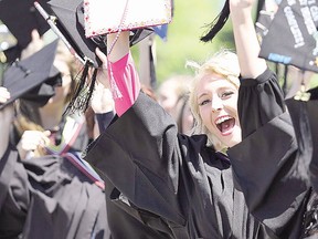 Social work graduate Brittney Drouin joins other graduates in a cheer before Algoma University's spring graduation at Roberta Bondar Pavilion in Sault Ste. Marie, Ont., on Saturday, June 11, 2016. (BRIAN KELLY/THE SAULT STAR/POSTMEDIA NETWORK) ORG XMIT: POS1607141138420613
