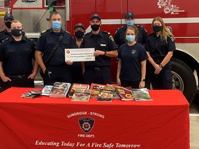 The Sundridge-Strong Fire Department is getting $5,000 from Enbridge Gas. Fire Chief Andrew Torance, front row wearing the blue mask, says the money will buy education material to help the volunteer firefighters better serve the area communities. Submitted Photo