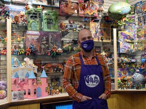 The Village Toy Castle opened to the public Dec. 1 in Brucefield, offering a wide range of action figures, dolls, figurines, board games and more. Pictured is owner Isaac Elliott-Fisher in front of the shop’s museum display of action figures through the years. Dan Rolph