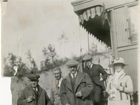 •	1972.453.Q – Town of Peace River Mayor Dr. W.B.L. Donald and Mrs. (Reba) Donald with His Excellency Governor General, the Duke of Devonshire (with umbrella), during the governor general’s September 1920 tour of the Peace Country. Mr. McGregor (left, wearing plaid cap) – in charge of the vice-regal train. The man on the train step – aide-de camp to              governor general.