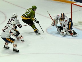 Matvey Petrov of the North Bay Battalion sees his shot go wide against Mack Guzda of the visiting Barrie Colts in Ontario Hockey League play Sunday. Nathan Allensen, Jacob Frasca, applying a hook, and Brandt Clarke work to blunt the attack for Barrie, which won 8-2.
Sean Ryan Photo