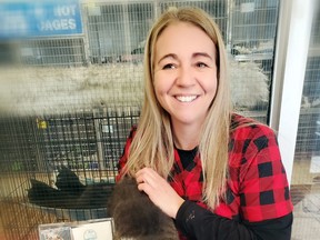 Sault Ste. Marie Humane Society’s Laura Smith and Meowzer, a cat in its care, are overwhelmed with donations flooding in as part of the Betty White Challenge.