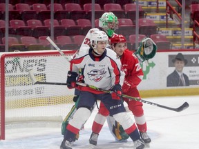 Soo Greyhounds winger Kalvyn Watson and Windsor Spitfires defenceman Louka Henault is OHL action at the GFL Memorial Gardens on Jan. 9. The Spitfires picked up a 3-2 shootout victory over the Greyhounds on Thursday night , overcoming a 2-0 third-period deficit.