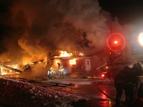 Firefighters prepare to pour water onto a south side section of the Hepworth Shallow Lake Legion building at about 5 a.m. Friday.
(Sun Times photo)