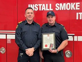 Deputy Fire Chief Andy Forsayeth, right, is presented with the 25-year Fire Service Ontario Medal by Fire Chief Andrew Torrance of the Sundridge Strong Volunteer Fire Department. 
Fraser Williamson Photo