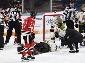 Goaltender Dom DiVincentiis of the North Bay Battalion receives attention from athletic therapist Andrew Sachkiw after taking a shoulder to the head from Danil Gushchin of the Niagara IceDogs in Ontario Hockey League action Tuesday night. Teammates Avery Winslow and Ty Nelson, with Niagara's Dakota Betts, monitor the situation.
Sean Ryan Photo