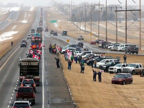 Supporters of the 'Freedom Convoy' gather on the edge of the Trans-Canada Highway east of Calgary, Monday. The truckers and their supporters will pass through North Bay, Ont., Friday on their way to Ottawa to protest the federal government's COVID-19 vaccine mandate for cross-border truckers. Photo by Gavin Young/Postmedia.