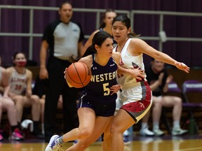 Ariane Saumure (5) competes for the Western Mustangs in OUA women's basketball action against the Algoma Thunderbirds.
