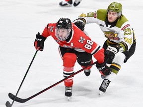 Nic Sima of the North Bay Battalion competes with Liam Van Loon of the Niagara IceDogs in Ontario Hockey League action Tuesday night at the Meridian Centre. The Troops, who lost 3-2 via shootout, host the Mississauga Steelheads on Thursday night.
Sean Ryan Photo