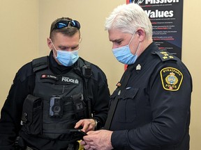 Stratford police Const. Darren Fischer, one of three officers currently involved in the Stratford Police Service's ongoing body worn camera pilot project, shows Stratford police Chief Greg Skinner some footage on his iPod captured by the camera attached to the front his vest. (Galen Simmons/The Beacon Herald)