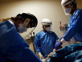FILE PHOTO: Medical staff treat a coronavirus disease (COVID-19) patient in the Intensive Care Unit (ICU) at the Providence Mission Hospital in Mission Viejo, California, U.S., January 25, 2022.  REUTERS/Shannon Stapleton/File Photo