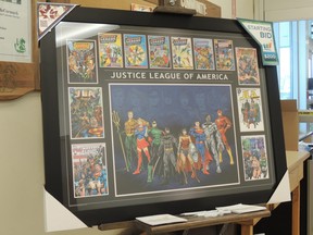 The new print at Sobeys is entitled  " Justice League with Covers " .This is an open edition print officially licensed by Warner Bros. In the center of the print are the seven original Justice League of America characters...Green Lantern, Flash, Superman, Batman, Wonder Woman, Aquaman, and Martian Manhunter .Arranged on either side and along the top of the print are Cyborg.Replica comic covers.  SUBMITTED
