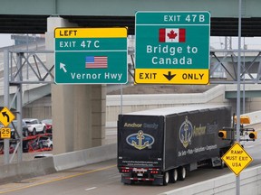 A commercial truck heads for the Ambassador Bridge at the international border crossing that connects with Windsor and Detroit. (REUTERS)