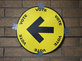 A sign directs voters to a polling station. The provincial election is June 2.