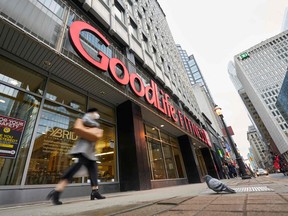 A woman walks by a closed GoodLife Fitness centre in Toronto on January 5, 2022.