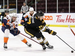 Sarnia Sting's Ryder McIntyre (77) is chased by Flint Firebirds' Zack Terry (44) in the first period at Progressive Auto Sales Arena in Sarnia, Ont., on Saturday, Jan. 8, 2022. Mark Malone/Chatham Daily News/Postmedia Network