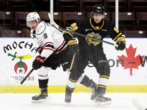 Sarnia Sting's Ty Voit, right, tangles with Owen Sound Attack's Servac Petrovsky in the first period at Progressive Auto Sales Arena in Sarnia, Ont., on Friday, Jan. 21, 2022. Mark Malone/Chatham Daily News/Postmedia Network