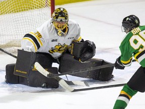 Sarnia Sting goalie Ben Gaudreau makes a save against London Knights forward Landon Sim in the third period of their OHL game at Budweiser Gardens in London, Ont., on Sunday, Jan. 16, 2022. Derek Ruttan/The London Free Press/Postmedia Network