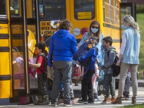 Students at Eagle Heights public shool in London get on their school buses. (Mike Hensen/The London Free Press)