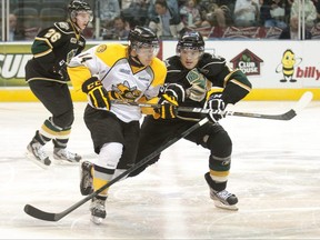 London Knights' Tommy Hughes, right, stays close to Sarnia Sting's Reid Boucher during an OHL preseason game at the John Labatt Centre in London, Ont., on Friday, Aug. 31, 2012. (CRAIG GLOVER The London Free Press/QMI Agency)