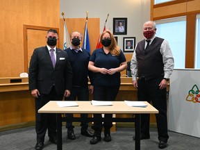 Beaumont Mayor Bill Daneluik, Beaumont Minor Football Association representative Dan McKinnon, Beaumont Minor Football Association president Leslie Stacey and Black Gold School Division superintendent Bill Romanchuk at the signing of the memorandum of agreement for the planned field house. (Black Gold School Division)