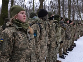 Civilians, including Tatiana, left, 21, a university veterinary medicine student who is also enrolled in a military reserve program, participate in a Kyiv Territorial Defence unit training on a Saturday in a forest on Jan. 22, 2022 in Kyiv, Ukraine.