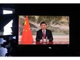 Chinese President Xi Jinping is seen on a TV screen speaking remotely at the opening of the World Economic Forum in Davos on Jan. 17. He warned that confrontation between major powers could have "catastrophic consequences."