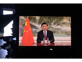 Chinese President Xi Jinping is seen on a TV screen speaking remotely at the opening of the World Economic Forum in Davos on Jan. 17. He warned that confrontation between major powers could have "catastrophic consequences."