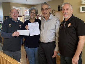 Raffle chair Wayne McGillivary (from left to right), Sue and Roy Rebeiro and committee member Mike Drewniak take a celebratory photo after the Rebeiro's won the latest draw for a dream vacation.