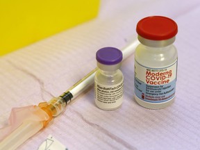 Vials of the Pfizer-BioNTech and Moderna COVID-19 vaccines sit with other vaccination supplies on a cart Friday, October 15, 2021 at Hastings Prince Edward Public Health in Belleville, Ont. (Luke Hendry/Postmedia Network)