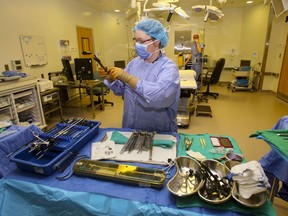 Scrub nurse Stephanie Williams prepares surgical instruments in an operating room at Belleville General Hospital Monday, April 28, 2014. Postponed surgeries are to resume gradually after the lifting on Jan. 31 of a provincial directive which paused them to preserve hospitals' capacities.