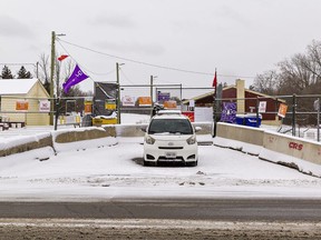 A security vehicle sits at the entrance to the former Arrowdale Municipal Golf Course on Stanley Street on Sunday morning.