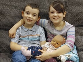 Liam Dyball, age 4, and his seven-year-old sister Bailey welcome their newborn baby sister Avery to the family.