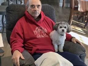 Bill McDowall, of Norfolk County, shares his favorite chair with Daisy as he continues his rehabilitation from knee replacement surgery at Brantford General Hospital. McDowall was one of the first patients to participate in a new program that enables patients who receive joint surgery to return home after the procedure instead of staying in hospital for more than a day.