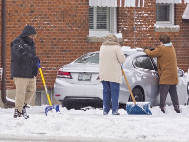 Clearing snow from sidewalks, driveways and vehicles was a team effort for many Brantford residents on Monday January 17, 2022. The area received about 25 cm of snowfall overnight in the first significant snow storm of 2022. Brian Thompson/Brantford Expositor/Postmedia Network