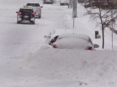 Brantford residents who park on city streets face a daunting task of shovelling to get into their vehicles, and city officials say it makes snow plowing less effective. The area received about 25 cm of snowfall overnight in the first significant snow storm of 2022. Brian Thompson/Brantford Expositor/Postmedia Network