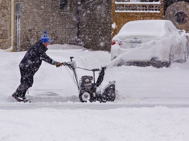 A Brier Park Road resident clears snow from the end of his driveway on Monday January 17, 2022 in Brantford, Ontario. The area received about 25 cm of snowfall overnight in the first significant snow storm of 2022.