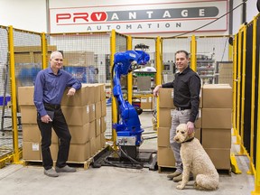 Alex Shamalov (left) and Peter Graham, co-owners of ProVantage Automation in Brantford show a palletizer, still in the assembly and testing phase, that their firm has designed for a coffee packaging company.