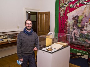 Nathan Etherington, program and community co-ordinator at the Brant Museum and Archives shows items in a new exhibit that launches on Monday. Brian Thompson/Brantford Expositor/Postmedia Network