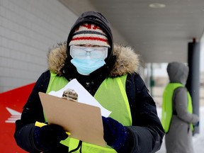 An employee of the Upper Canada Family Health Team does intake at Brockville's COVID-19 vaccination centre on a cold, snowy Sunday afternoon, Jan. 2, 2022. (RONALD ZAJAC/The Recorder and Times)