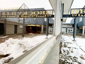 The Brockville Shopping Centre sign is reflected in a window on a grey Wednesday afternoon. (RONALD ZAJAC/The Recorder and Times)