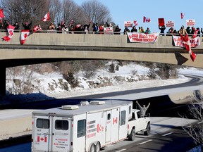 A passenger in the "Freedom Convoy" protest flashes a victory sign to supporters on the Stewart Boulevard overpass in Brockville on Friday morning. (RONALD ZAJAC/The Recorder and Times)
