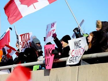 Local supporters of the "Freedom Convoy" cheer on the truckers from the Stewart Boulevard overpass in Brockville on Friday morning. (RONALD ZAJAC/The Recorder and Times)