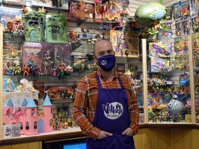 The Village Toy Castle opened to the public Dec. 1 in Brucefield, offering a wide range of action figures, dolls, figurines, board games and more. Pictured is owner Isaac Elliott-Fisher in front of the shop's museum display of action figures through the years. Dan Rolph