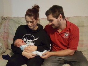 Mom Brittany Andrews and dad Joshua Derouchie-Delorme, at home with baby Onyx on Sunday, Jan. 2, 2022. Handout/Cornwall Standard-Freeholder/Postmedia Network