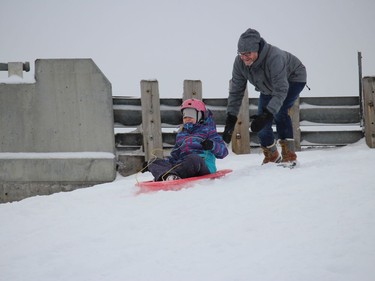 Dad Eric Lefebvre with a sendoff for Eleanor Lefebvre at a popular sliding hill in Cornwall. Photo on Sunday, January 2, 2022, in Cornwall, Ont. Todd Hambleton/Cornwall Standard-Freeholder/Postmedia Network