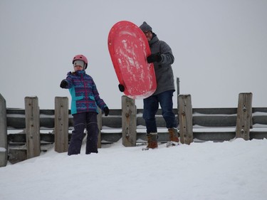 Dad Eric Lefebvre getting directions from Eleanor Lefebvre before her first run of the afternoon Sunday at a popular sliding hill in Cornwall. Photo on Sunday, January 2, 2022, in Cornwall, Ont. Todd Hambleton/Cornwall Standard-Freeholder/Postmedia Network